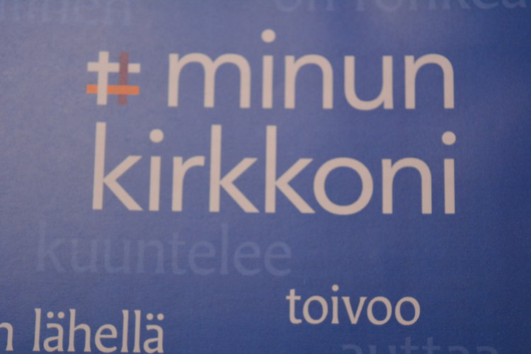 Kuvassa on vaalin tunnus Minun kirkkoni.